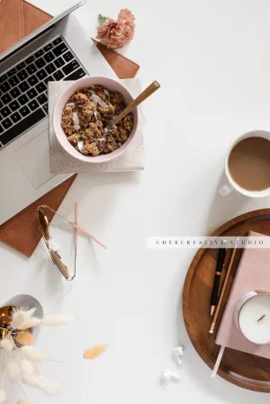 Granola, Laptop & Candle on White Background. Digital Image.